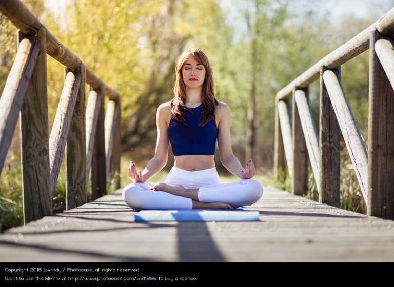 2311886-woman-doing-yoga-in-nature-lotus-figure-on-wooden-bridge-dot-photocase-stock-photo-large.jpeg